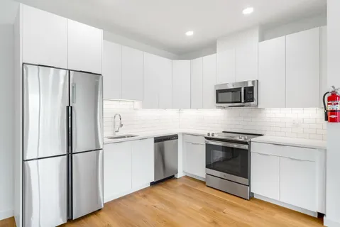 a kitchen with stainless steel appliances a refrigerator stove and microwave