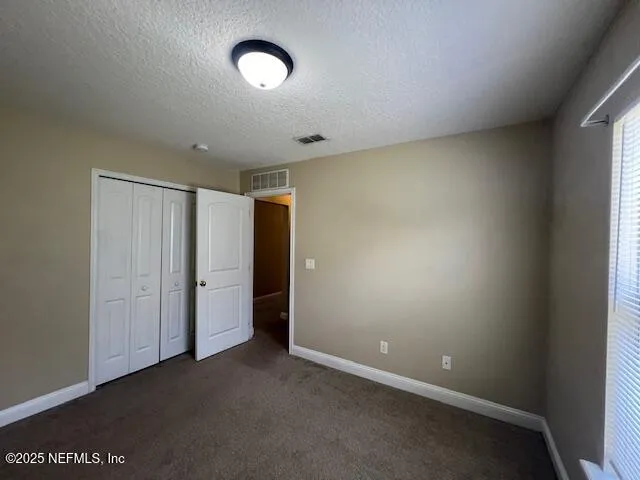 an empty room with a empty space and windows