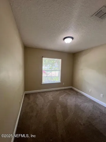 an empty room with closet area