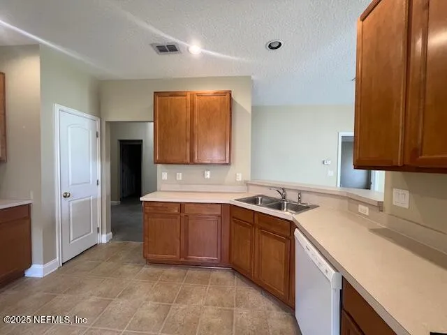 a view of a kitchen with a refrigerator cabinet and a refrigerator