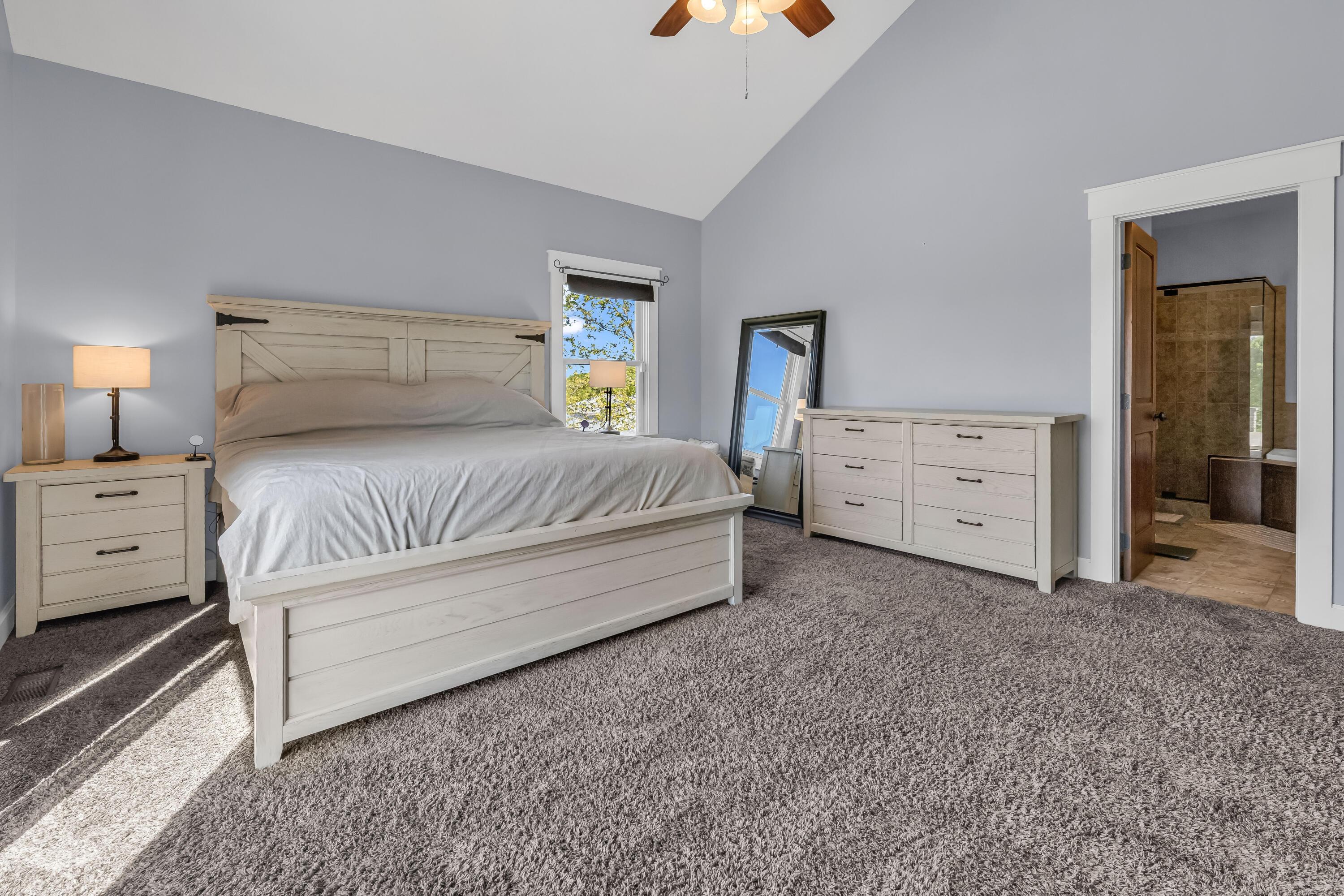 16689 Bailor Road Laurelville, OH 43135 - Photo 12 of 73 • Grey carpet
• Grey painted walls
• Cathedral ceiling
• Lighted ceiling fan
• Sliding doors to patio
• Faux fireplace remains