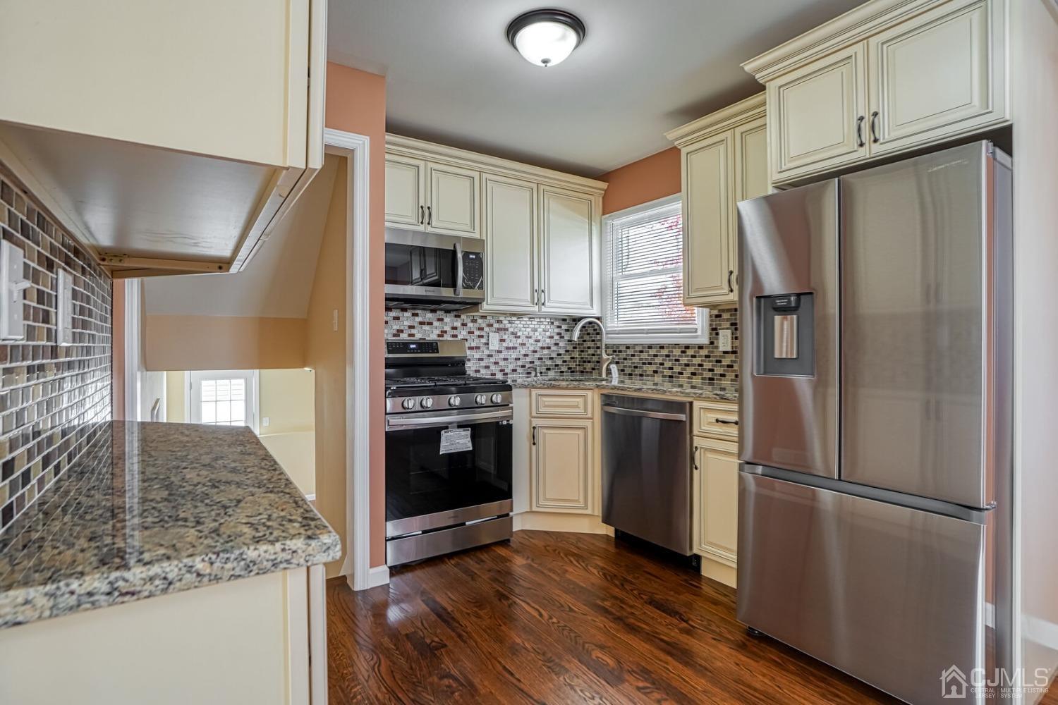 245 McFarlane Road Colonia, NJ 07067 - Photo 7 of 25 a kitchen with stainless steel appliances granite countertop a refrigerator stove and sink