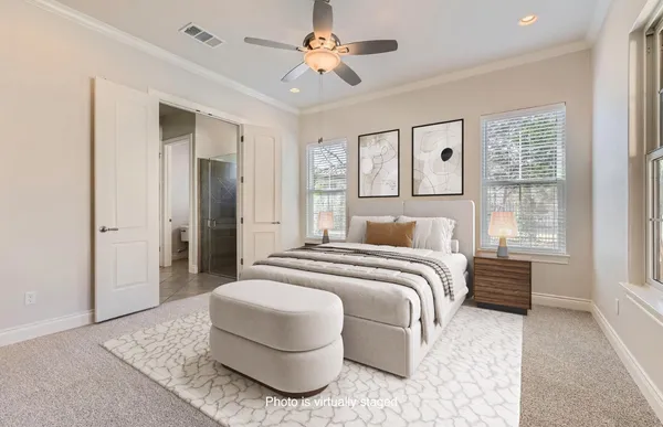 a spacious bedroom with a bed and a chandelier