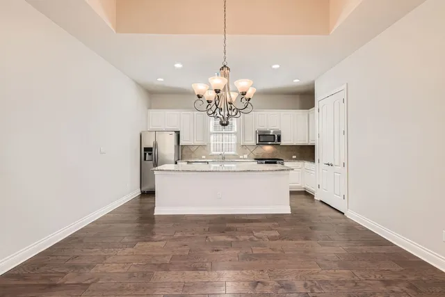 a view of kitchen with granite countertop cabinets
