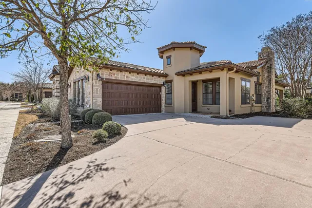 a view of a house with a yard and pathway