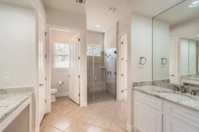 a spacious bathroom with a granite countertop sink mirror and a