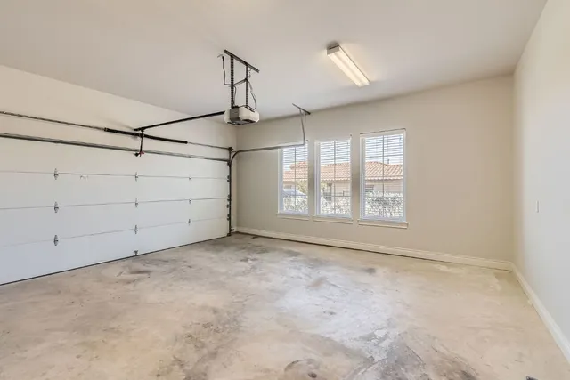 a view of a room with window and ceiling fan