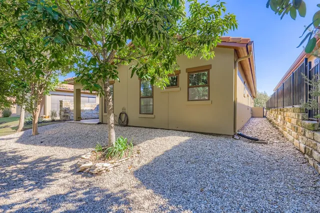 a view of a house with a tree in the background
