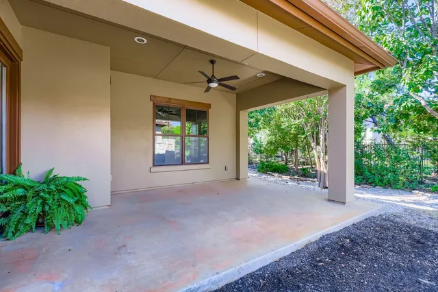 a view of a house with porch and garden