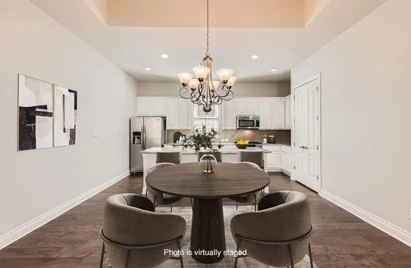 a view of a dining room with furniture and chandelier