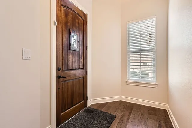 a view of an entryway with wooden floor