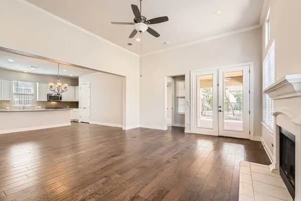 a view of an empty room with a fireplace and a window