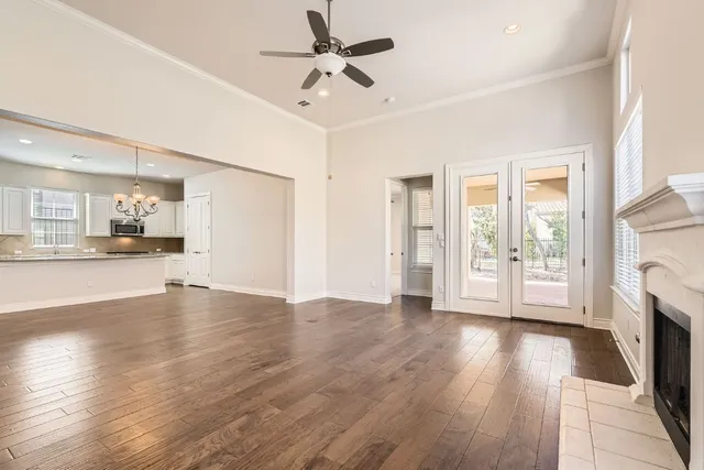 a view of an empty room with a fireplace and a window