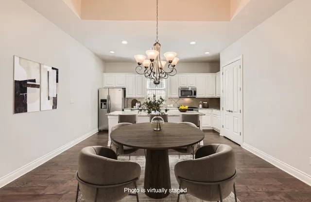 a view of a dining room with furniture and chandelier