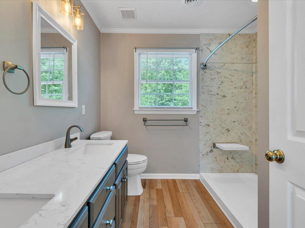 520 Scenic Drive Stuart, VA 24171 - Photo 43 of 83 a bathroom with a sink a toilet and a window