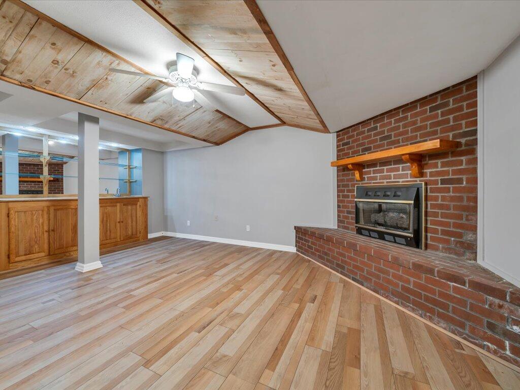 520 Scenic Drive Stuart, VA 24171 - Photo 55 of 83 a view of an empty room with wooden floor and a fireplace