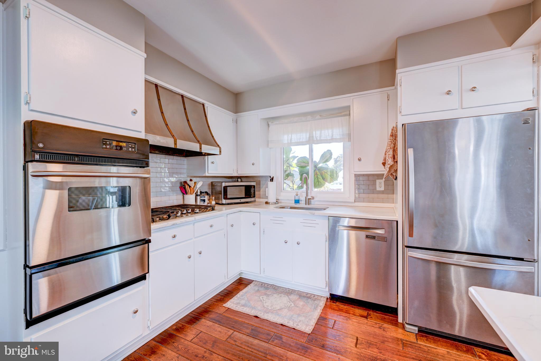 33 Dailey Drive Hamilton, NJ 08620 - Photo 4 of 27 a kitchen with a refrigerator sink stove and cabinets