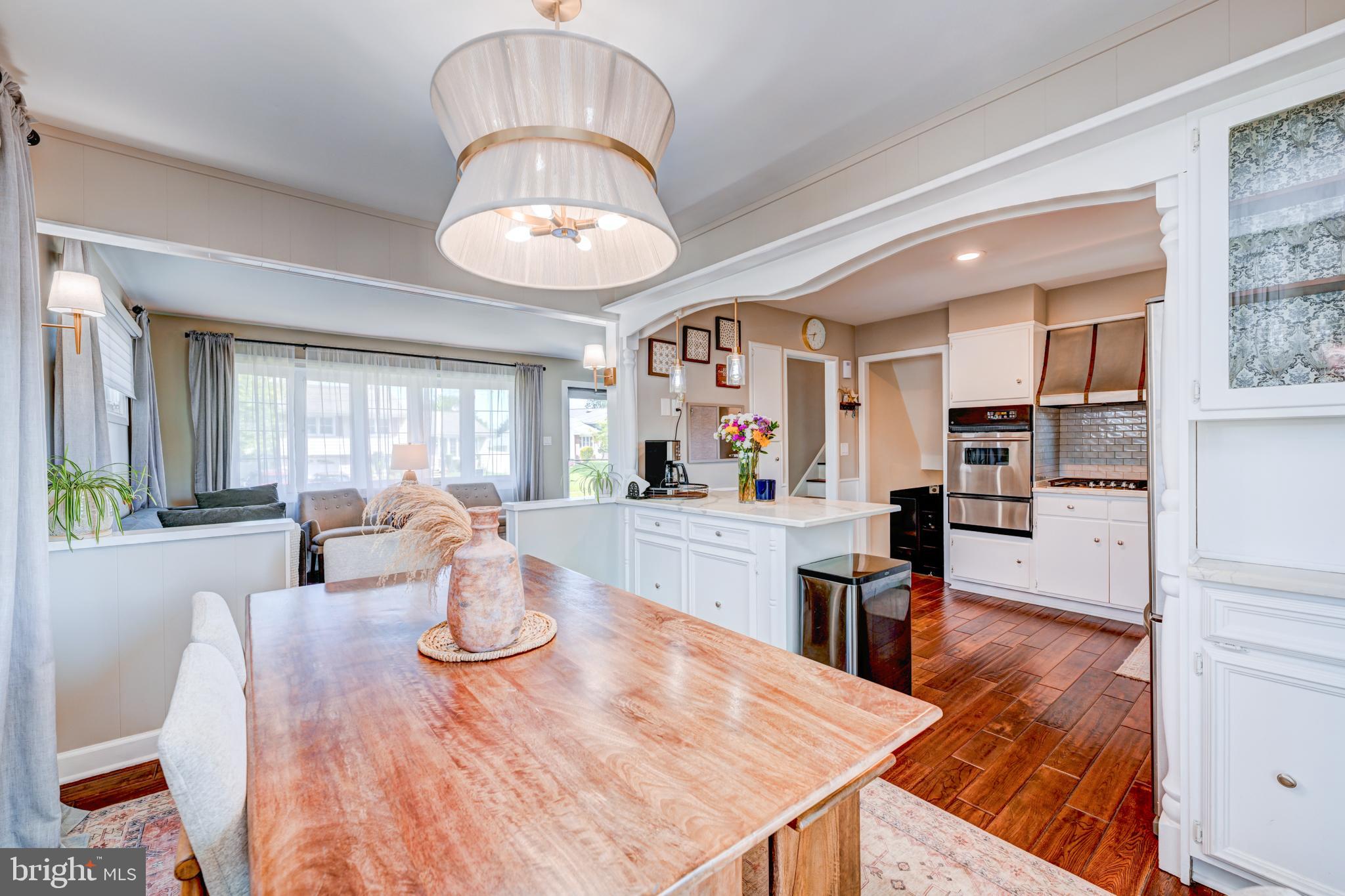 33 Dailey Drive Hamilton, NJ 08620 - Photo 7 of 27 a view of a dining room and livingroom with furniture wooden floor a chandelier