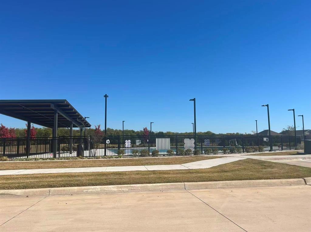 909 Calley Pear Trail Princeton, TX 75407 - Photo 15 of 17 a view of a swimming pool with a lawn chairs