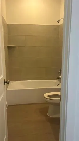 a bathroom with a shower and a toilet