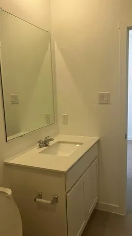 a bathroom with a sink and vanity