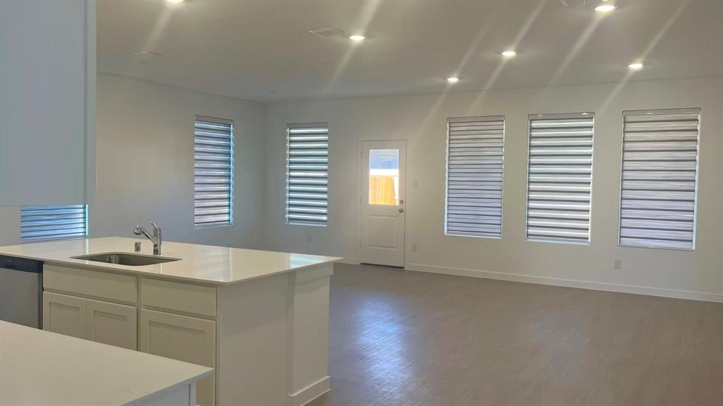 909 Calley Pear Trail Princeton, TX 75407 - Photo 17 of 17 a kitchen with a sink cabinets and wooden floor