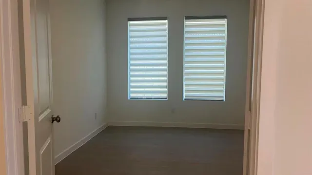 a kitchen with a sink cabinets and wooden floor