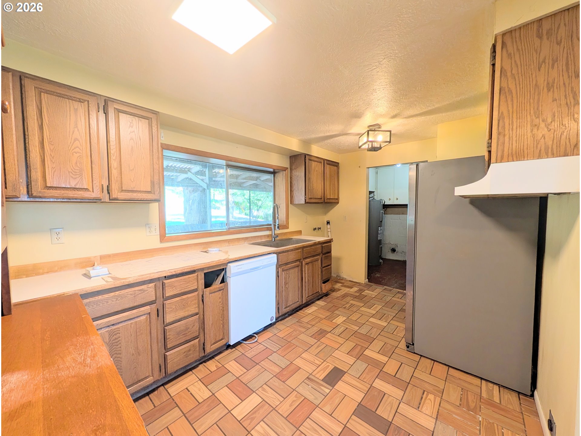 1624 Foley Street La Grande, OR 97850 - Photo 14 of 37 a large kitchen with stainless steel appliances a sink and cabinets