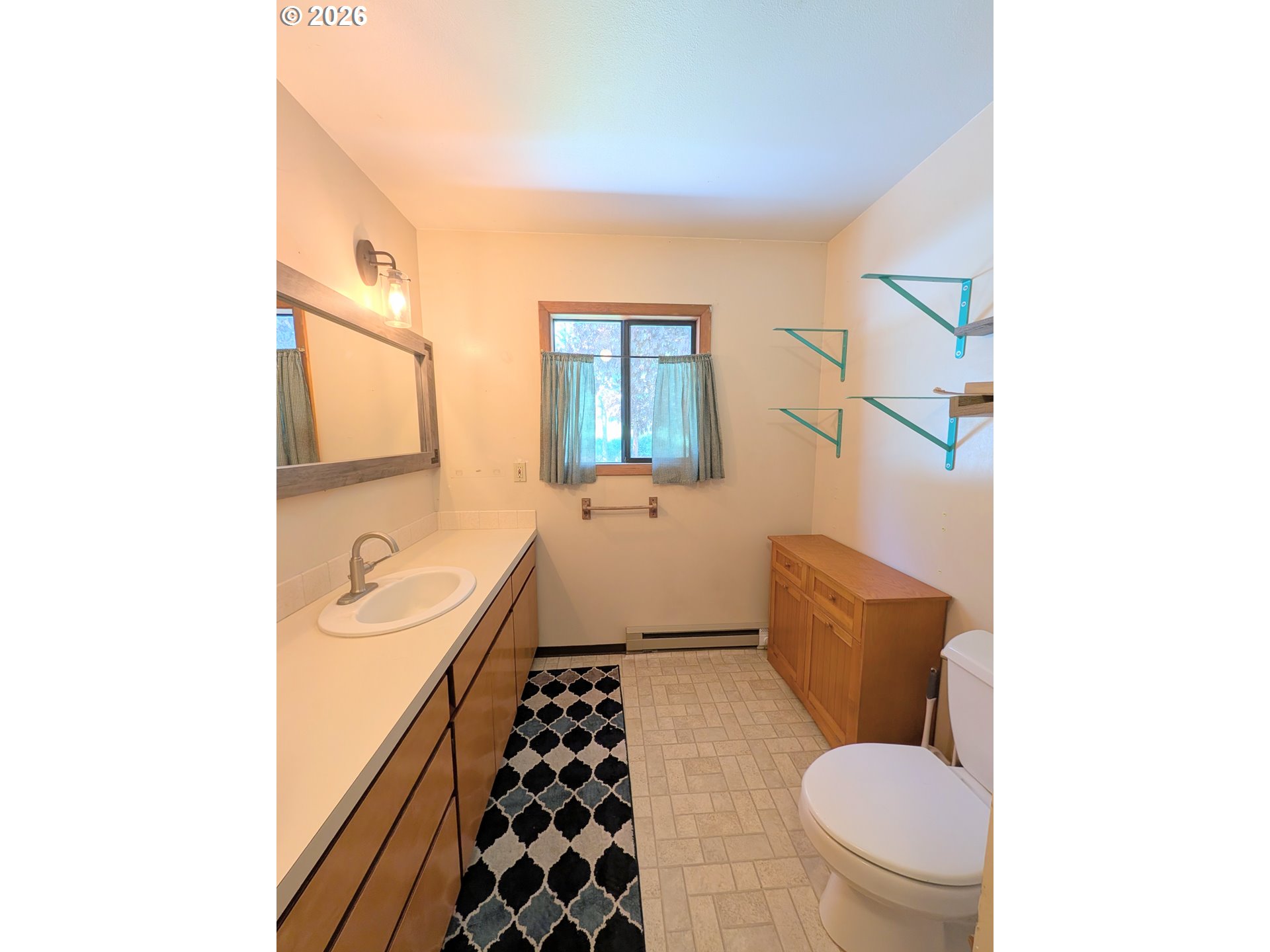1624 Foley Street La Grande, OR 97850 - Photo 29 of 37 a bathroom with a granite countertop toilet sink and mirror