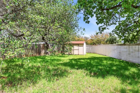 a view of a yard with a house in the background