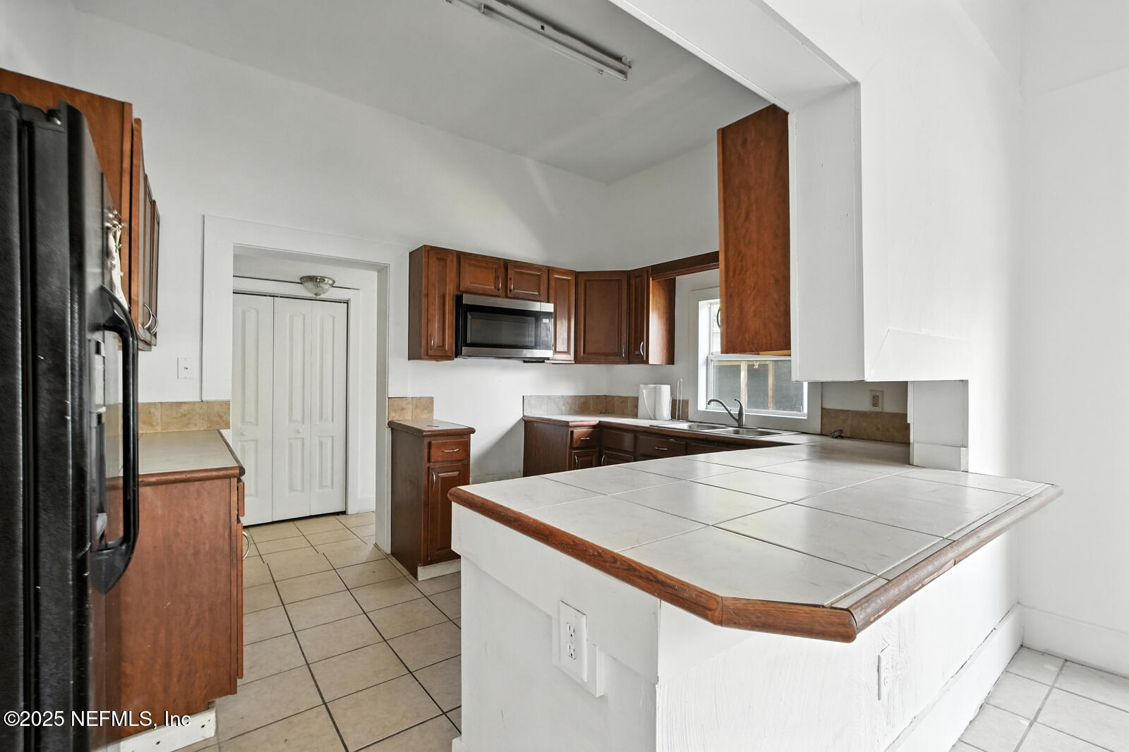 412 Madison Street Palatka, FL 32177 - Photo 12 of 29 a kitchen with a stove a sink and a refrigerator