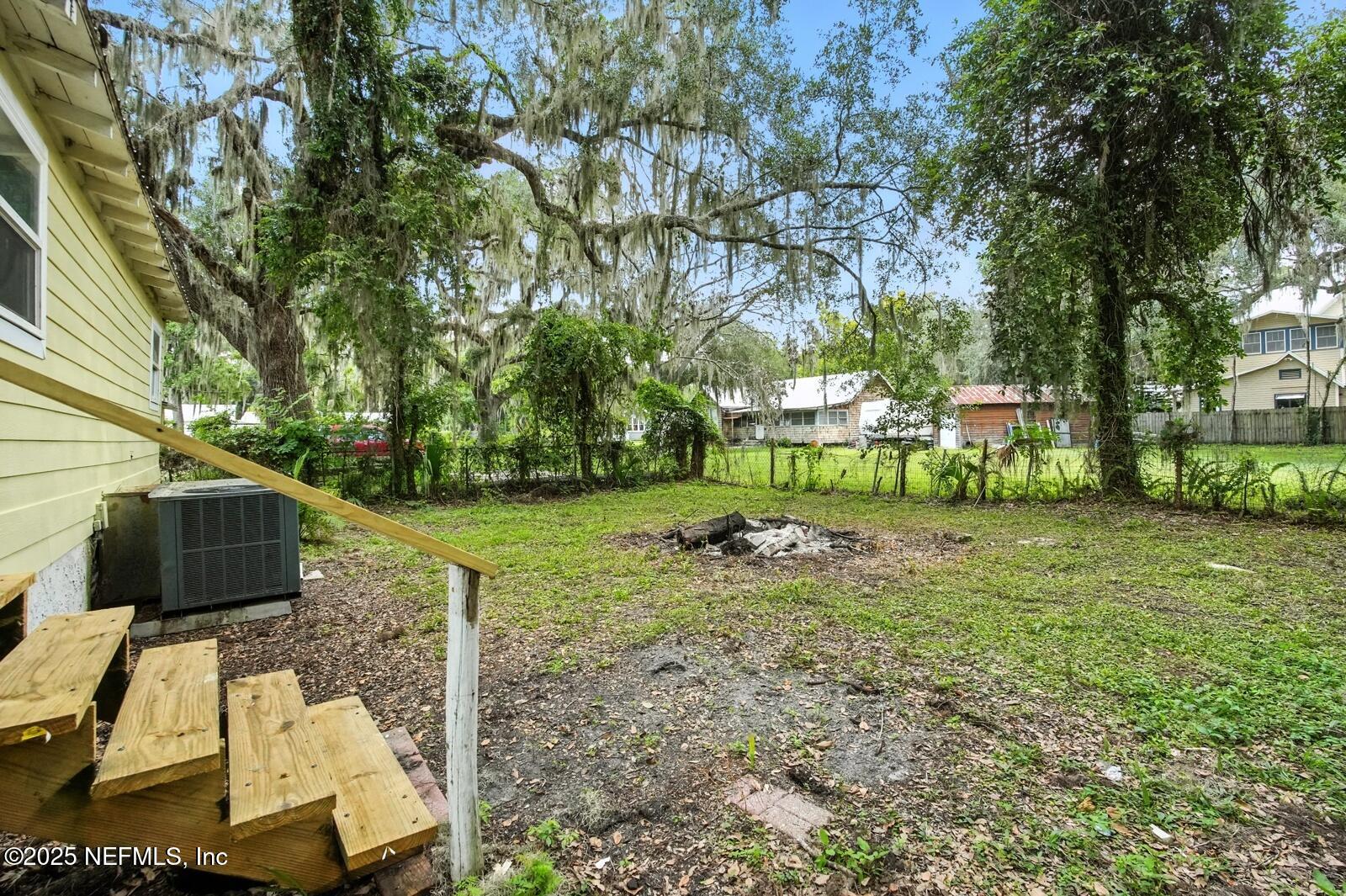 412 Madison Street Palatka, FL 32177 - Photo 23 of 29 a backyard of a house with table and chairs