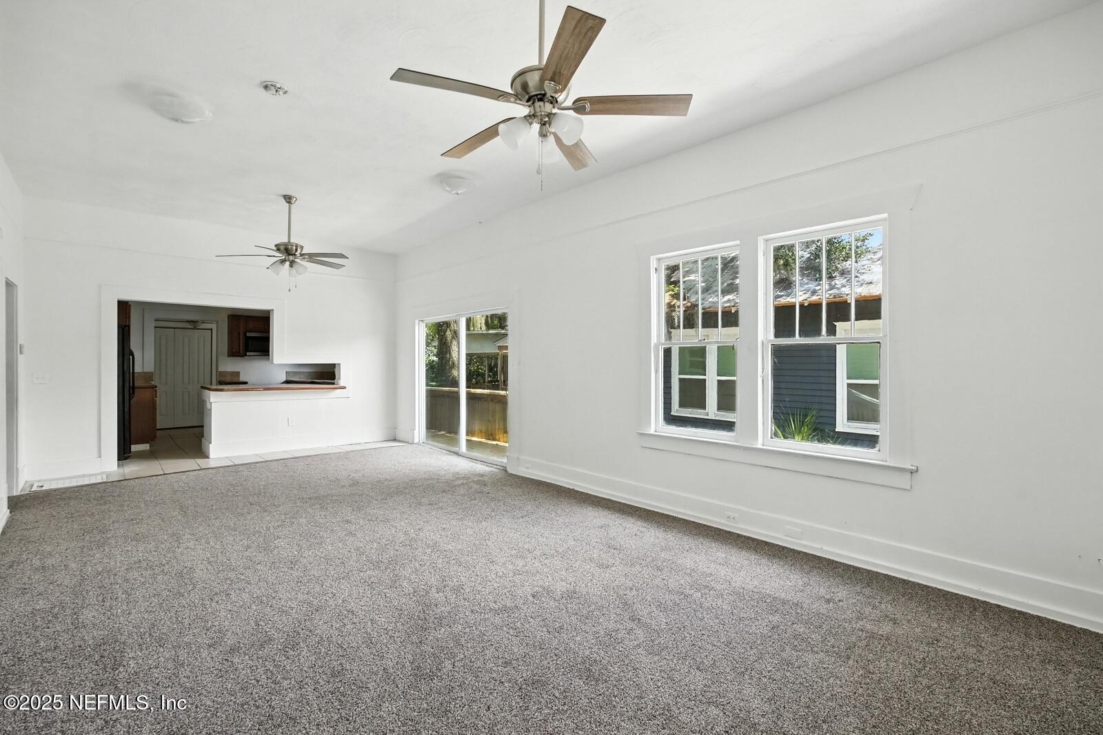 412 Madison Street Palatka, FL 32177 - Photo 8 of 29 a view of an empty room with a window and a kitchen
