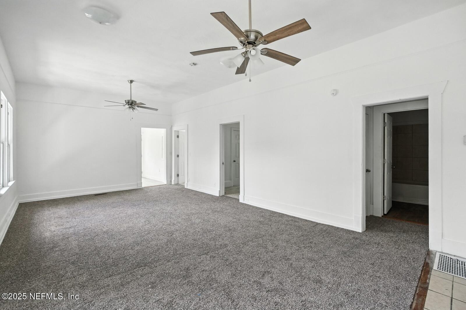 412 Madison Street Palatka, FL 32177 - Photo 10 of 29 an empty room with ceiling fan and closet area