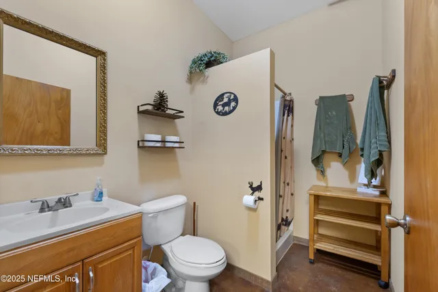 a living room with lots of furniture and kitchen view