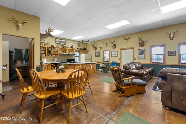 a living room with fireplace furniture and a rug