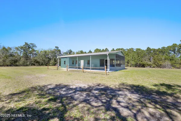 a view of a house with swimming pool and a yard