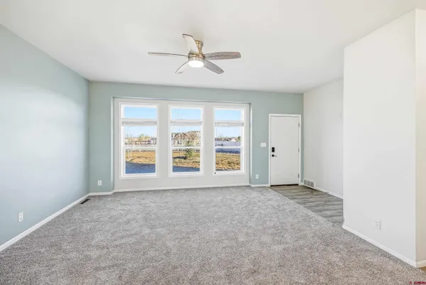 a view of livingroom with hardwood floor and a ceiling fan