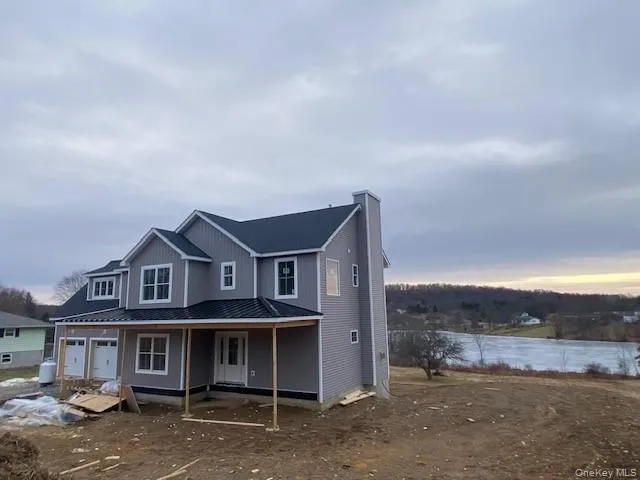 a view of a big house with a big yard and large tree