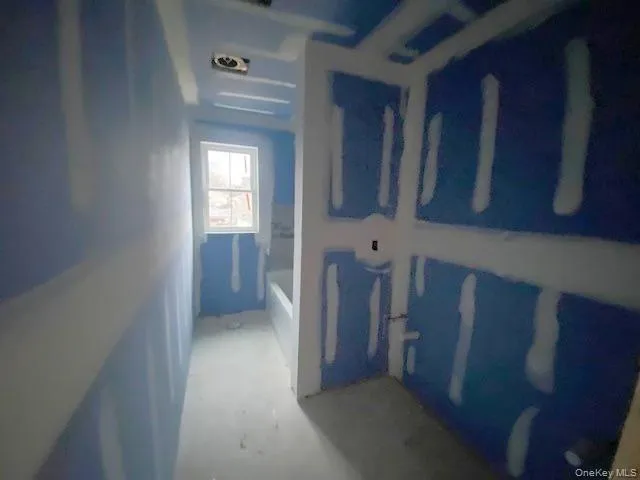 a view of a hallway with wooden cabinet and a window