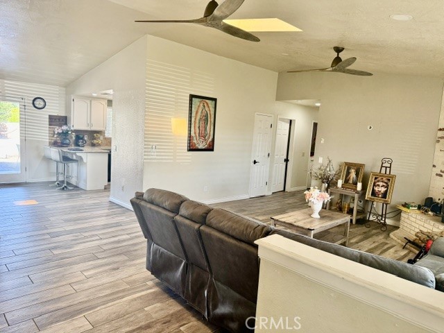13375 Rincon Road Apple Valley, CA 92308 - Photo 13 of 72 a living room with stainless steel appliances kitchen island granite countertop furniture and a wooden floor