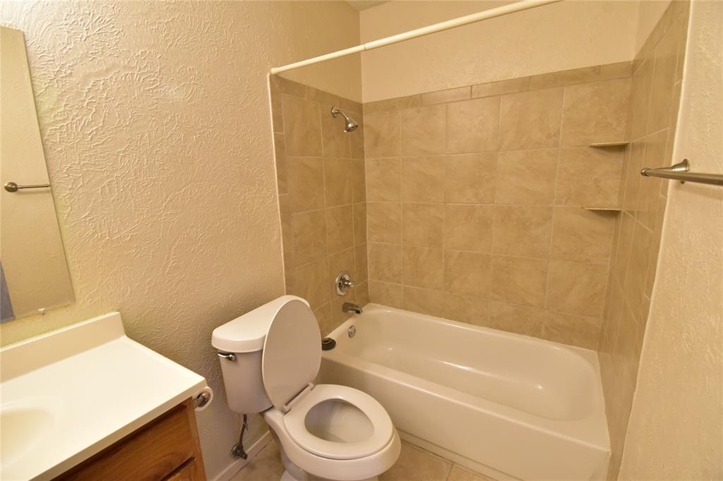 5414 Castleview Lane Garland, TX 75044 - Photo 13 of 20 Full bathroom featuring a textured wall, vanity, shower / bathtub combination, and tile patterned floors