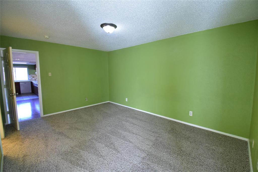 5414 Castleview Lane Garland, TX 75044 - Photo 14 of 20 Spare room with a textured ceiling and carpet floors