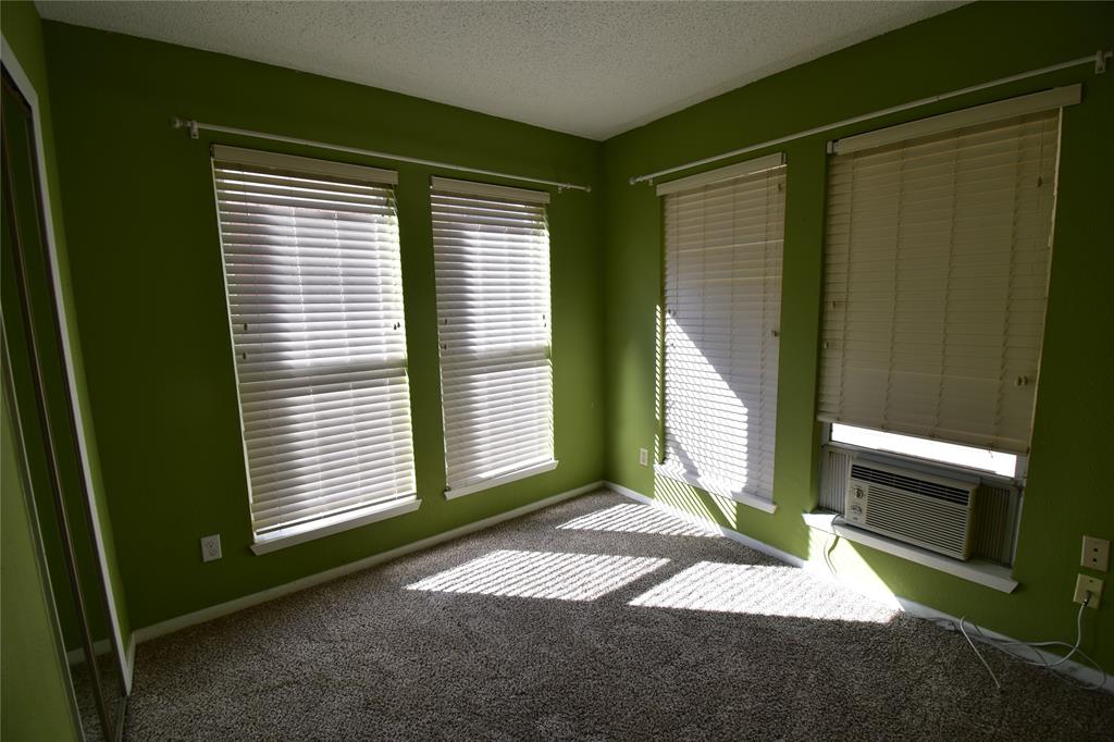5414 Castleview Lane Garland, TX 75044 - Photo 15 of 20 Empty room featuring a textured ceiling, carpet floors, and cooling unit