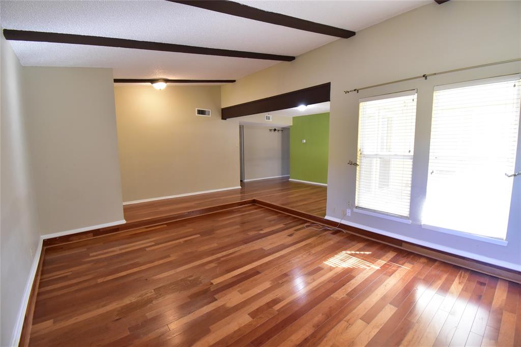 5414 Castleview Lane Garland, TX 75044 - Photo 3 of 20 Unfurnished room featuring hardwood / wood-style floors and beamed ceiling