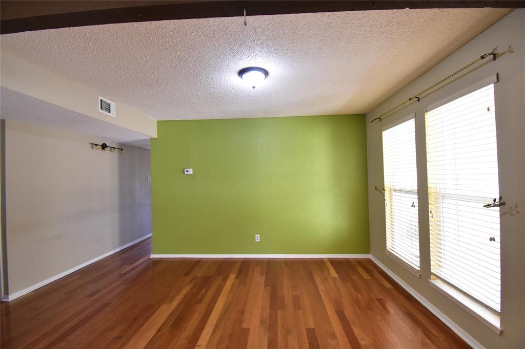 5414 Castleview Lane Garland, TX 75044 - Photo 4 of 20 Empty room featuring a textured ceiling and dark wood finished floors