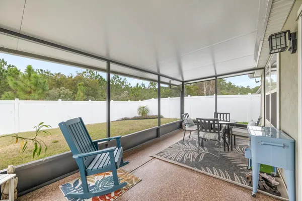 a dining room with furniture water view and a floor to ceiling window