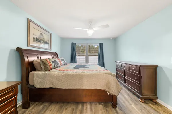 a bedroom with a bed and wooden floor