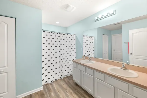 a bathroom with a sink a toilet a shower and a mirror