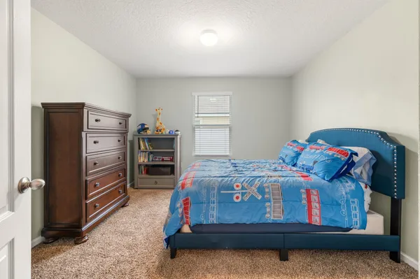 a bedroom with a bed and furniture